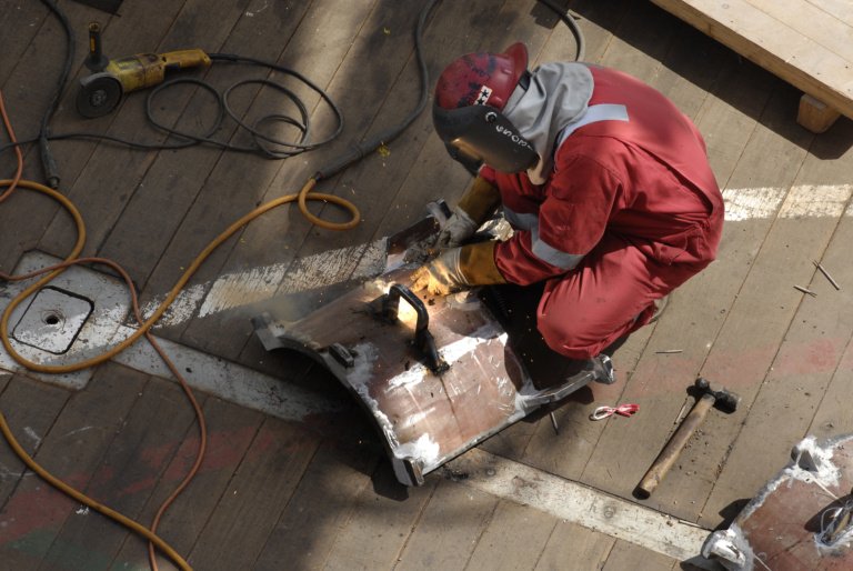 worker-working-suit-fixing-metal-rack